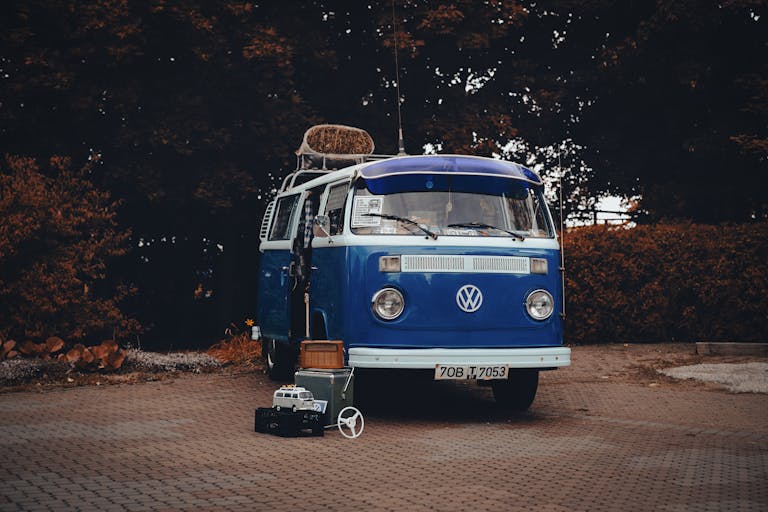 Retro blue Volkswagen van parked outdoors, showcasing classic design and travel vibe.